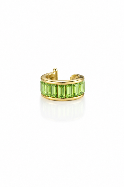 Gold ring with green gemstones on a white background