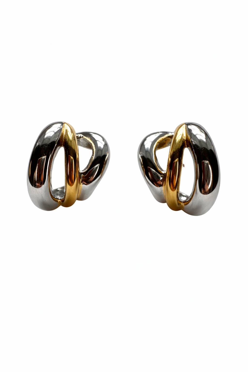 Pair of gold plated and silver plated hoop earrings on a white background