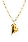 Gold heart-shaped pendant on a gold chain against a white background