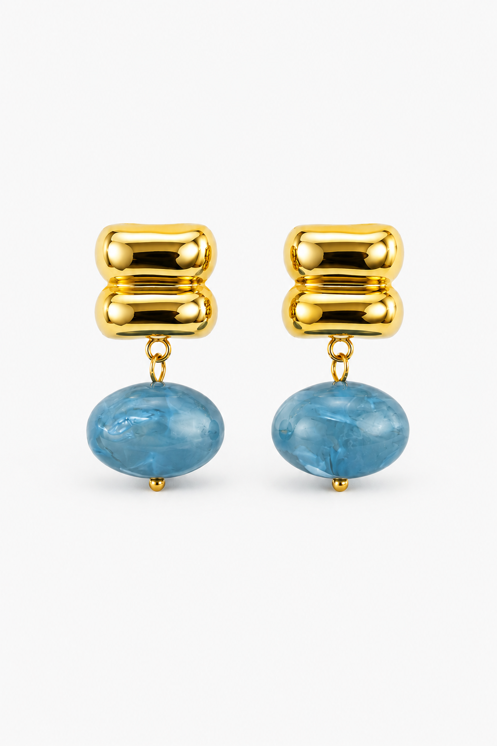 Gold earrings with blue stones on a white background