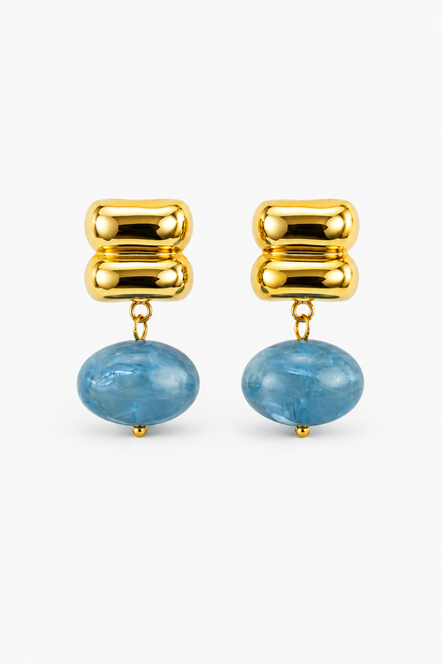 Gold earrings with blue stones on a white background