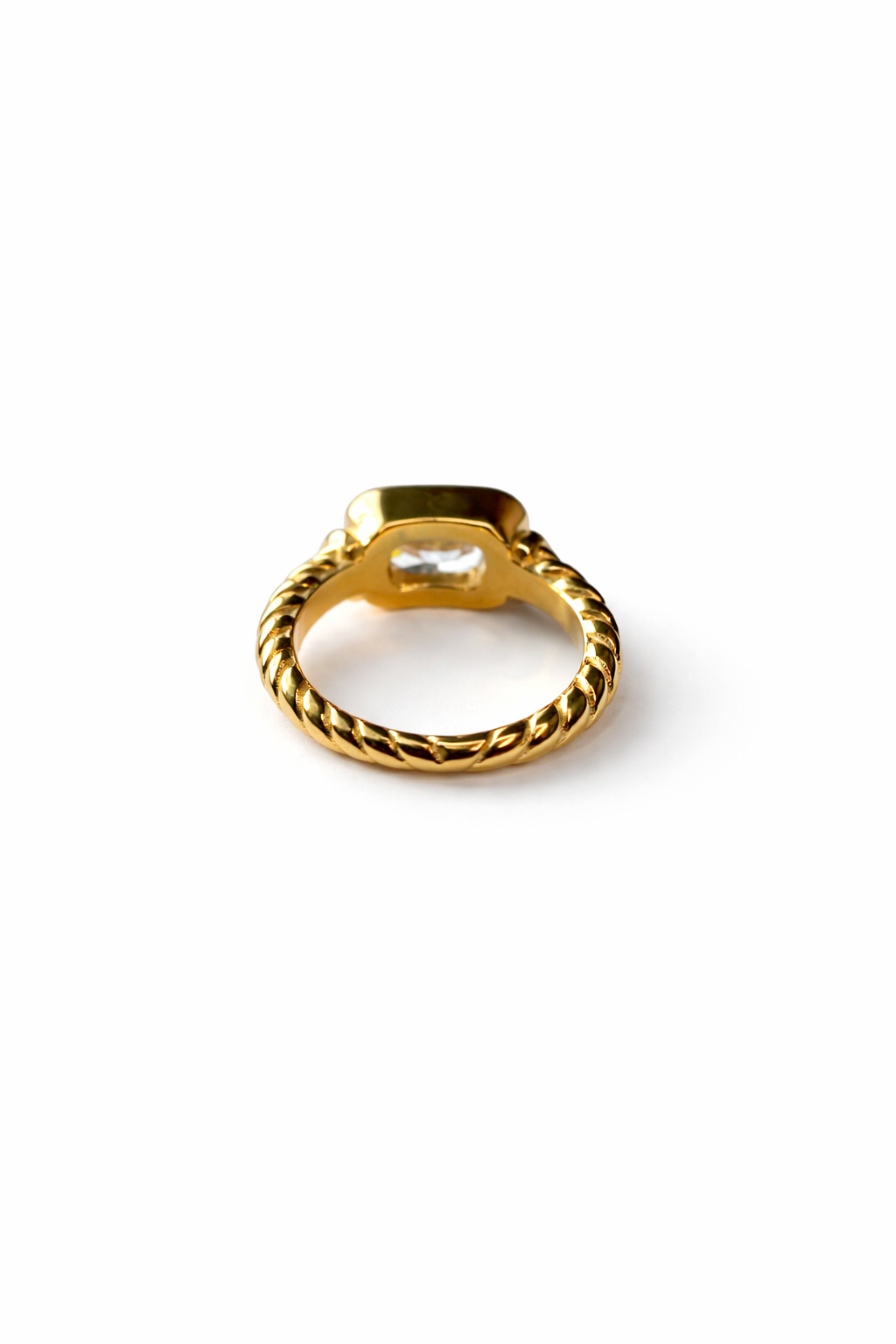 Gold ring with a textured band on a white background