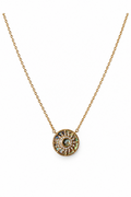 Gold necklace with a circular pendant on a white background