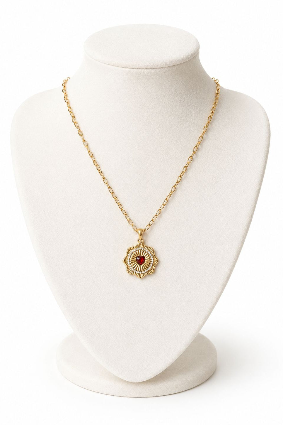Gold necklace on a white mannequin bust against a white background
