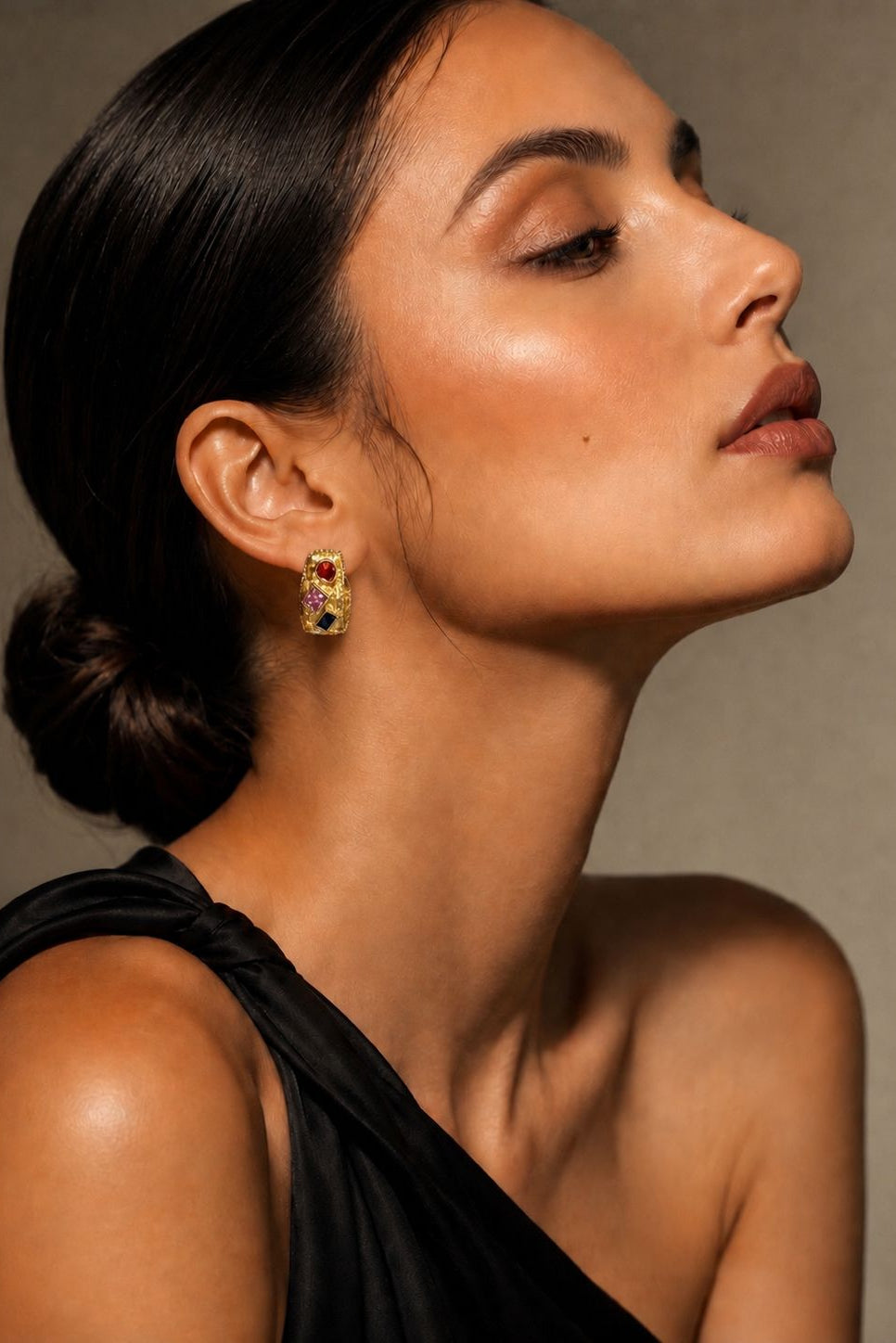 Woman wearing a black top with a neutral background