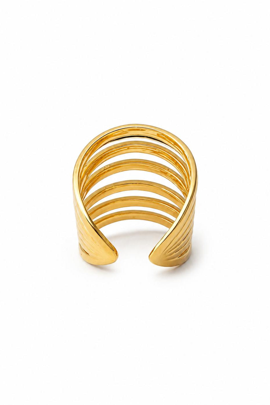 Gold ring with multiple bands on a white background