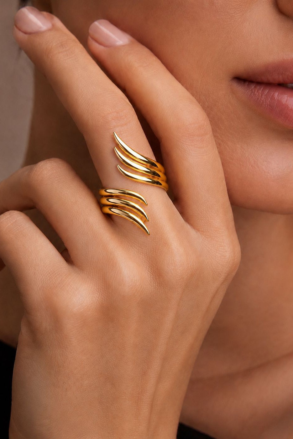 Gold ring on a finger with a neutral background