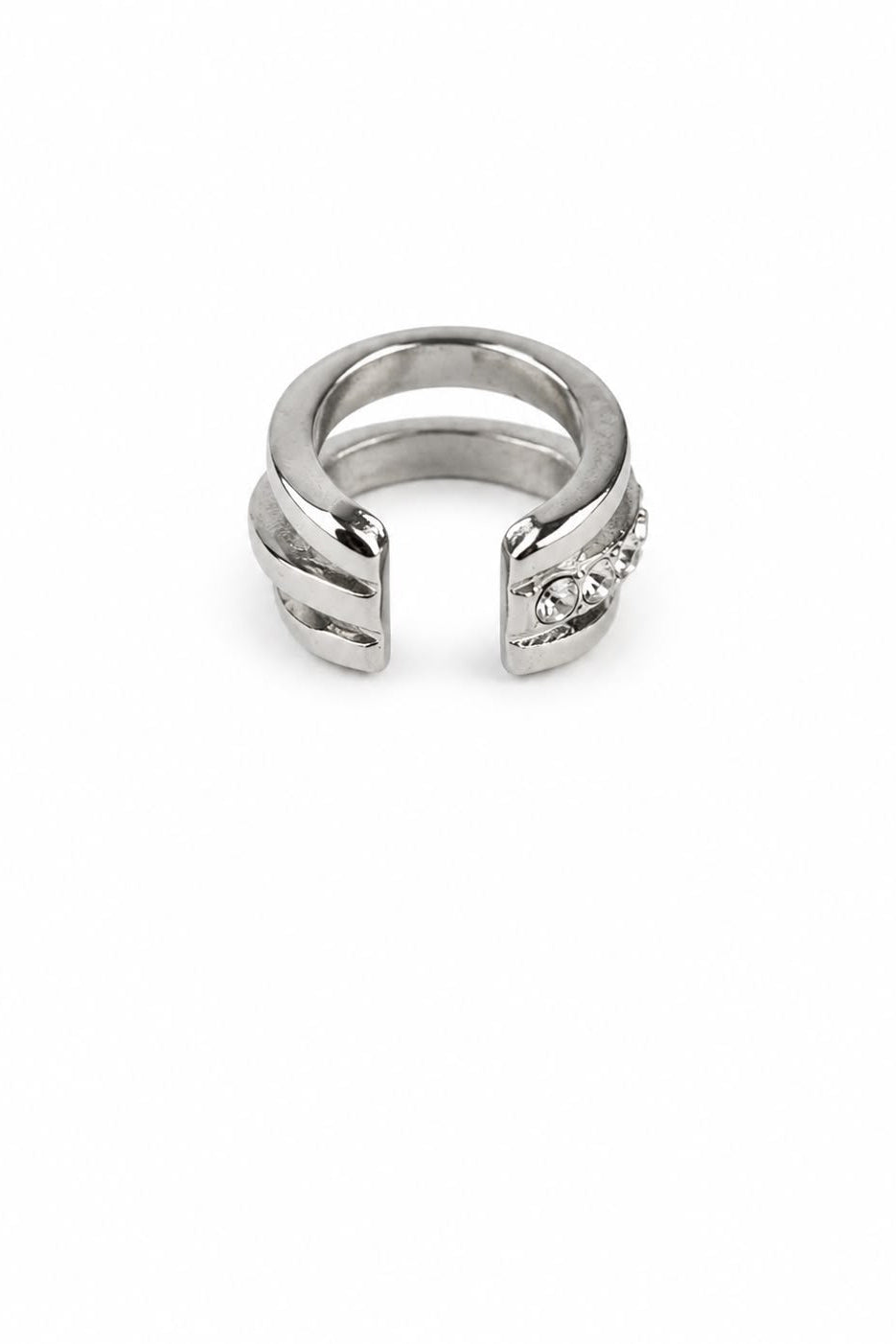 Silver cuff with a small gemstone on a white background