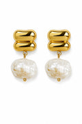 Gold earrings with large pearl-like beads on a white background