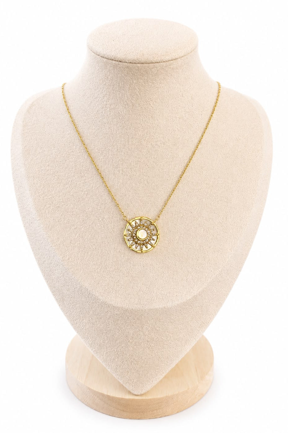 Gold-plated necklace on a beige mannequin bust with a white background