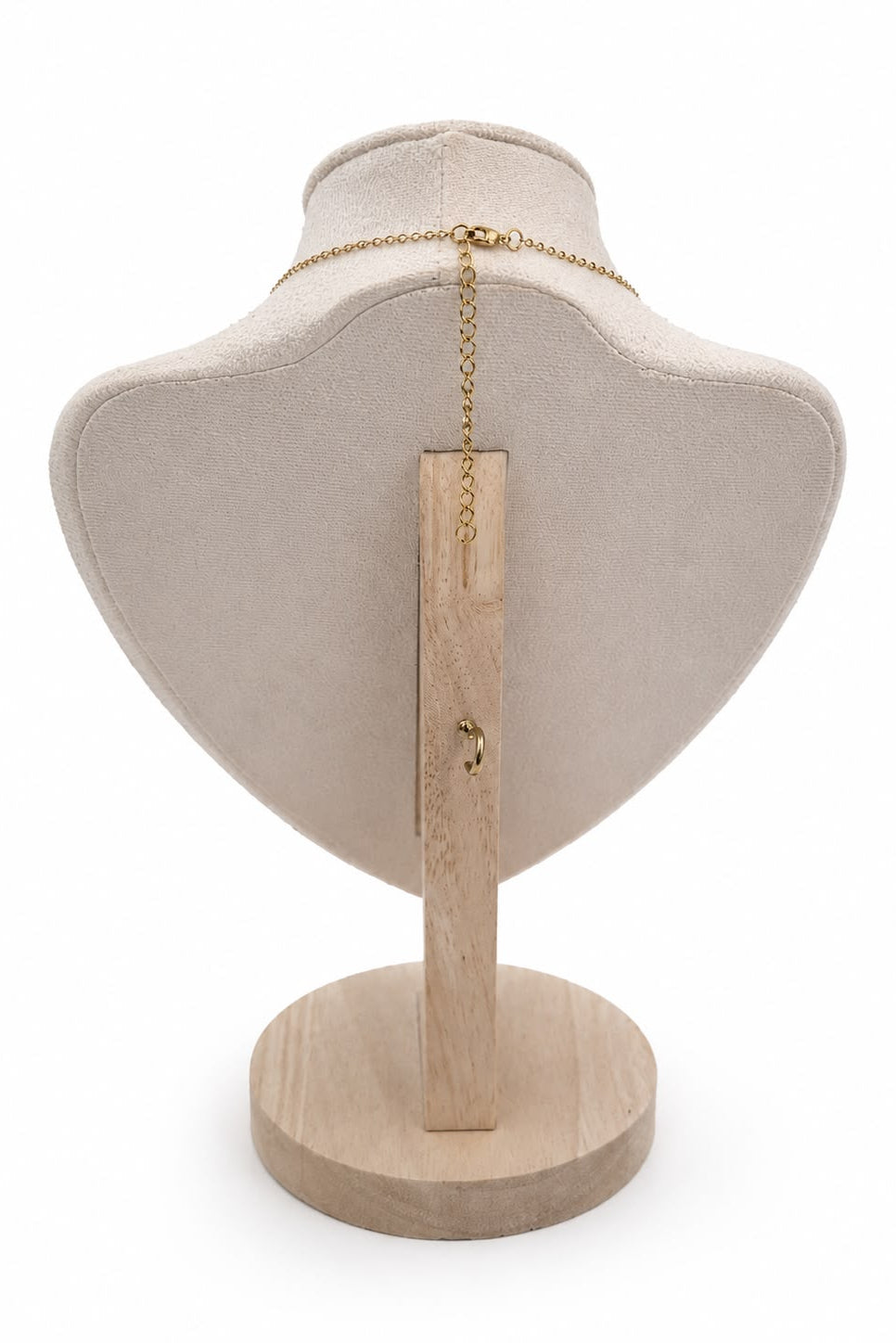 Necklace on a wooden stand with a beige fabric surface