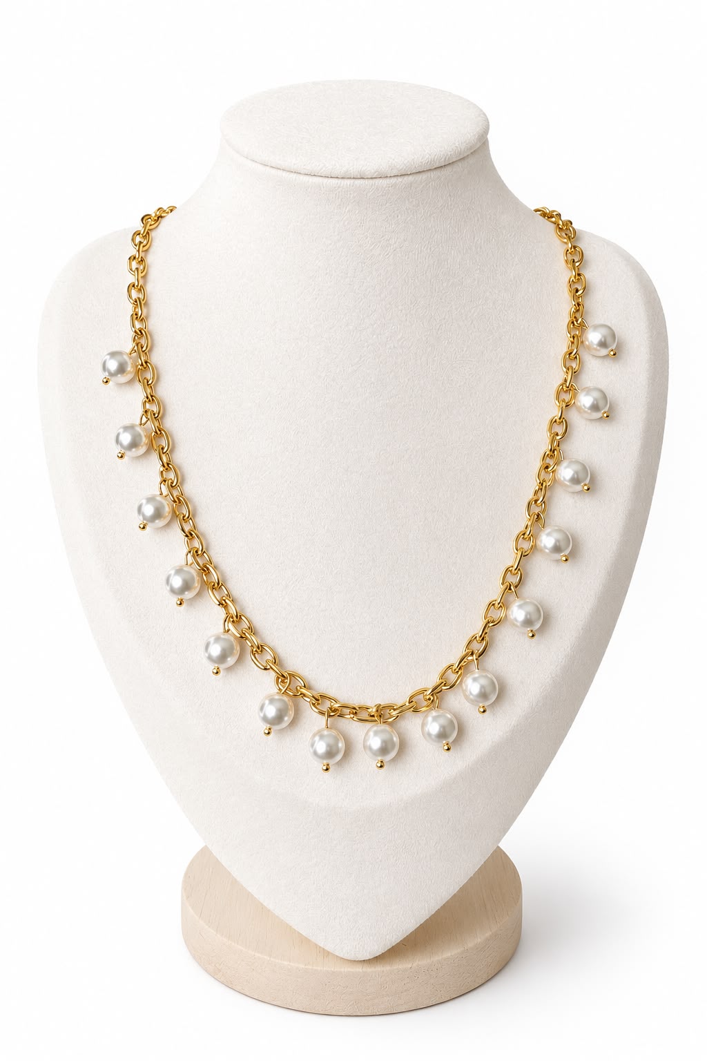 Gold chain necklace with pearls on a white mannequin bust