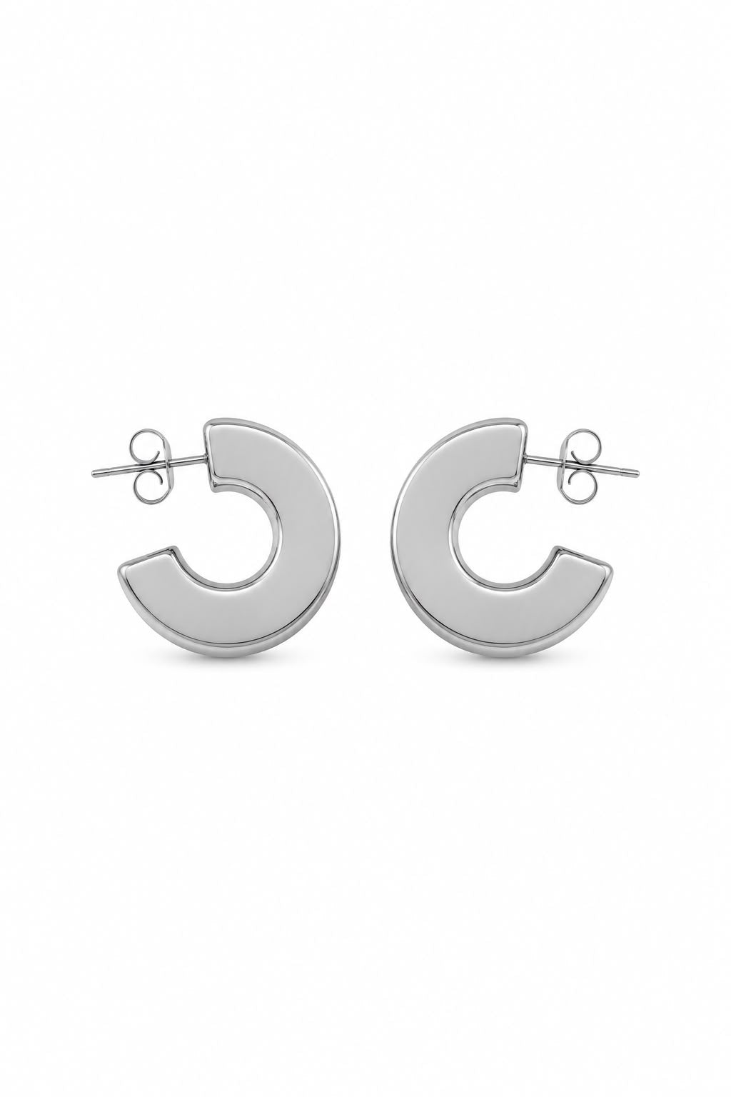 A pair of polished silver-tone hoop earrings with a thick, rounded semi-circular design and post-back closures, shown on a clean white background.