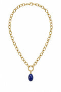 Gold chain necklace with a blue pendant on a white background