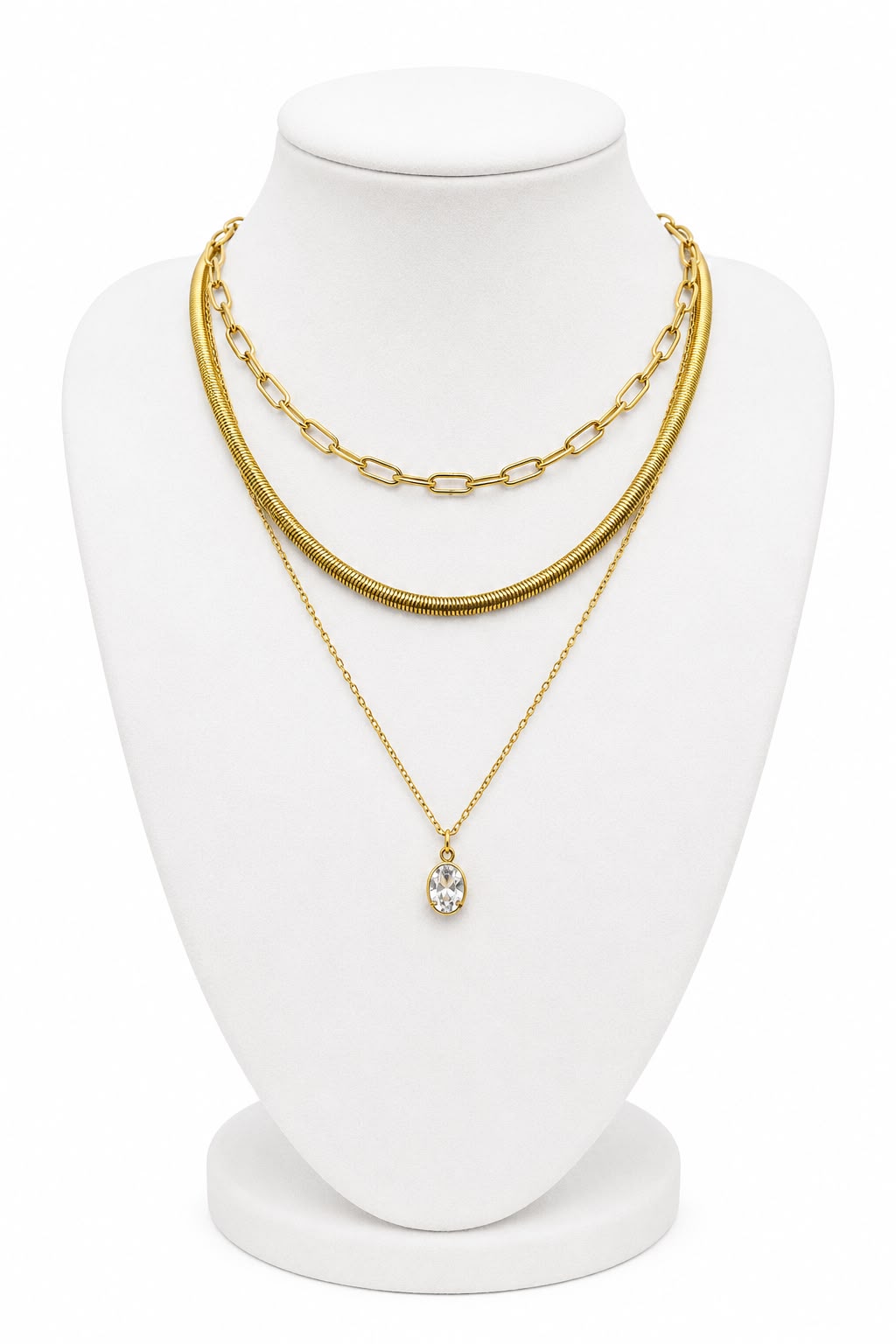 Gold chain and pendant necklace on a white mannequin bust