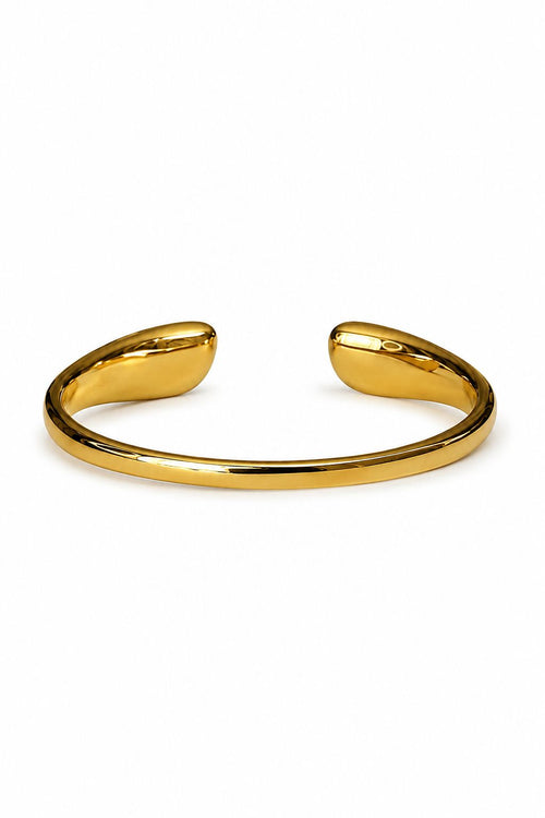 Gold bangle on a white background